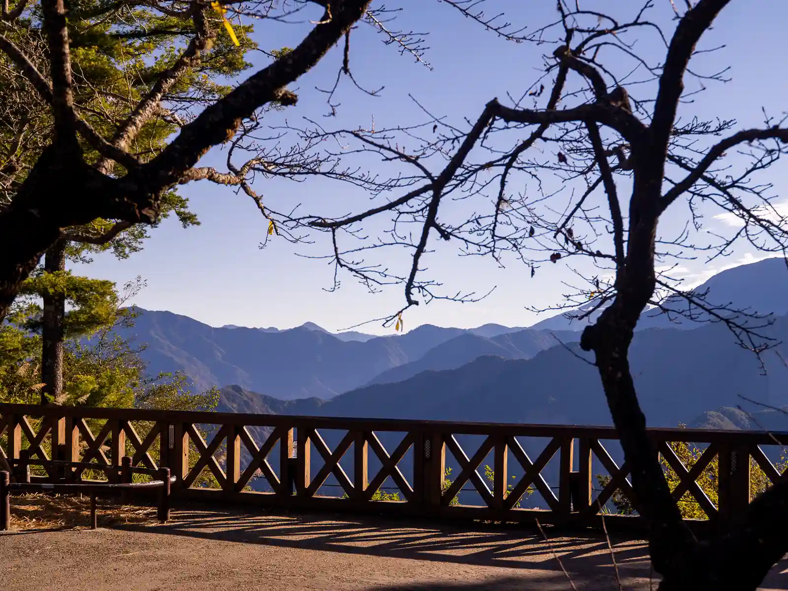 A mountain range is bathed in a soft-golden light.