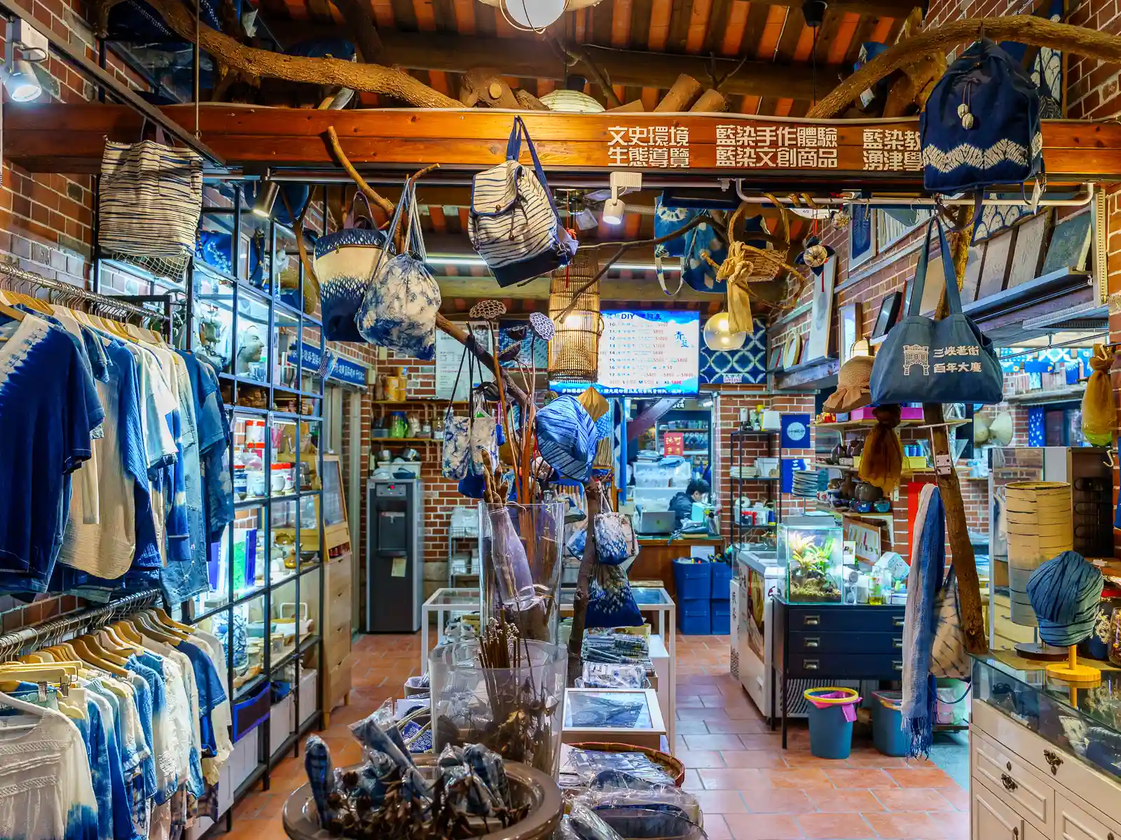 Indigo-dyed shirts, hats, bags, and other products are on display at the Sanxia Indigo Dyeing Centre.