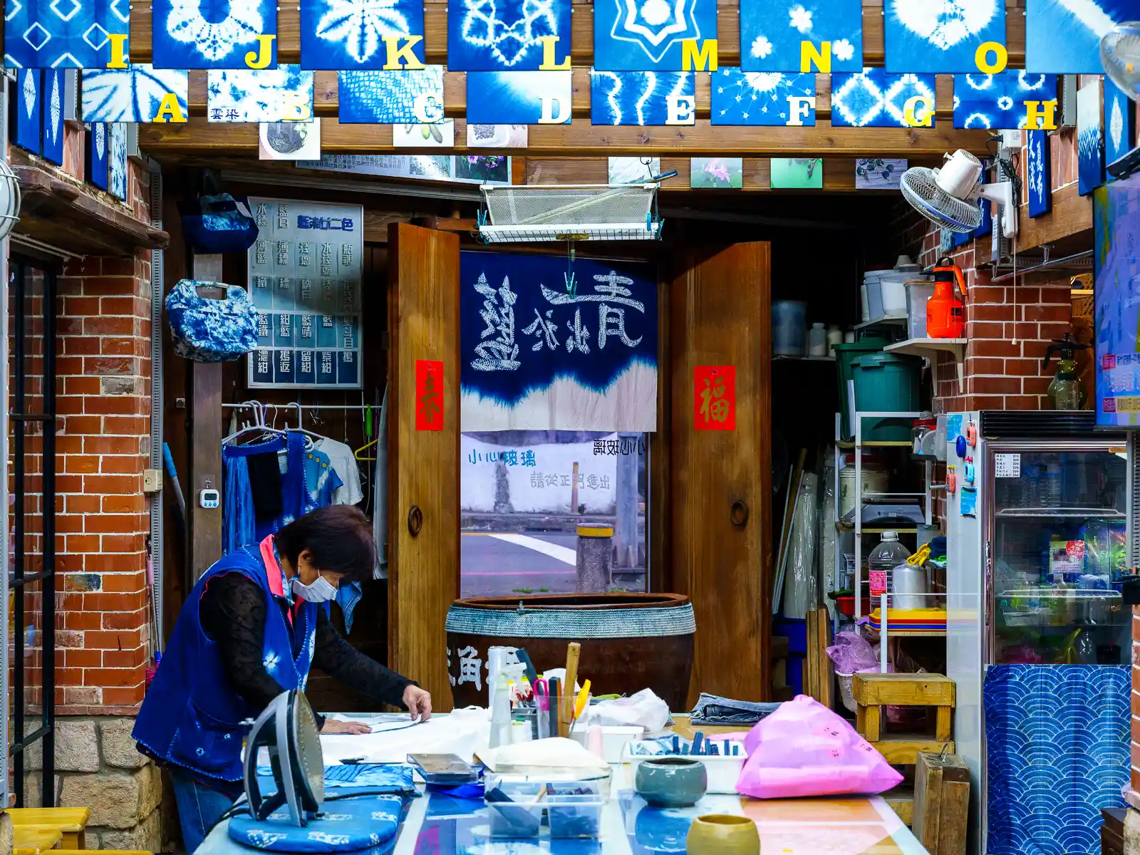 An employee prepares materials for dyeing at Sanxi Indigo Dyeing Centre.