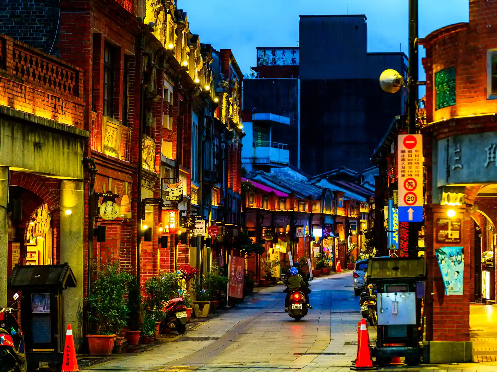 The buildings of Sanxia Old Street are are illuminated and glow a warm red hue at dusk.