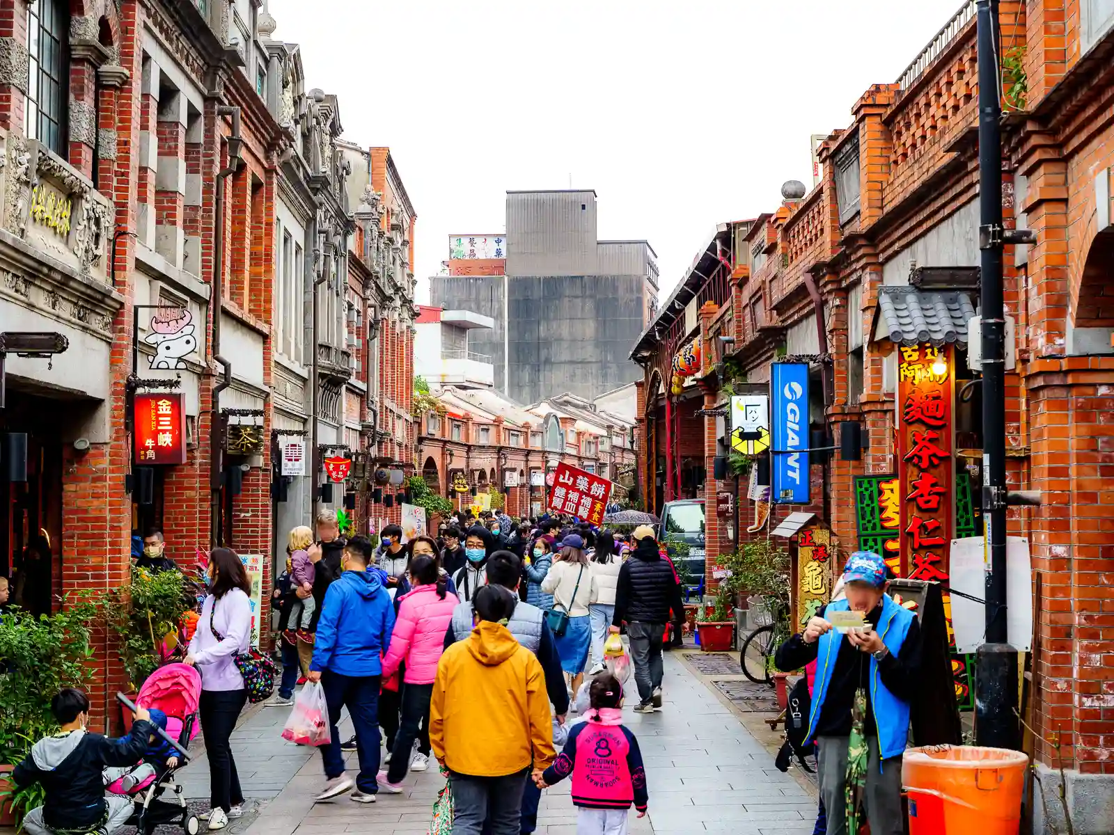 Two story red-brick and stone buildings line the sides of Sanxia Old Street.