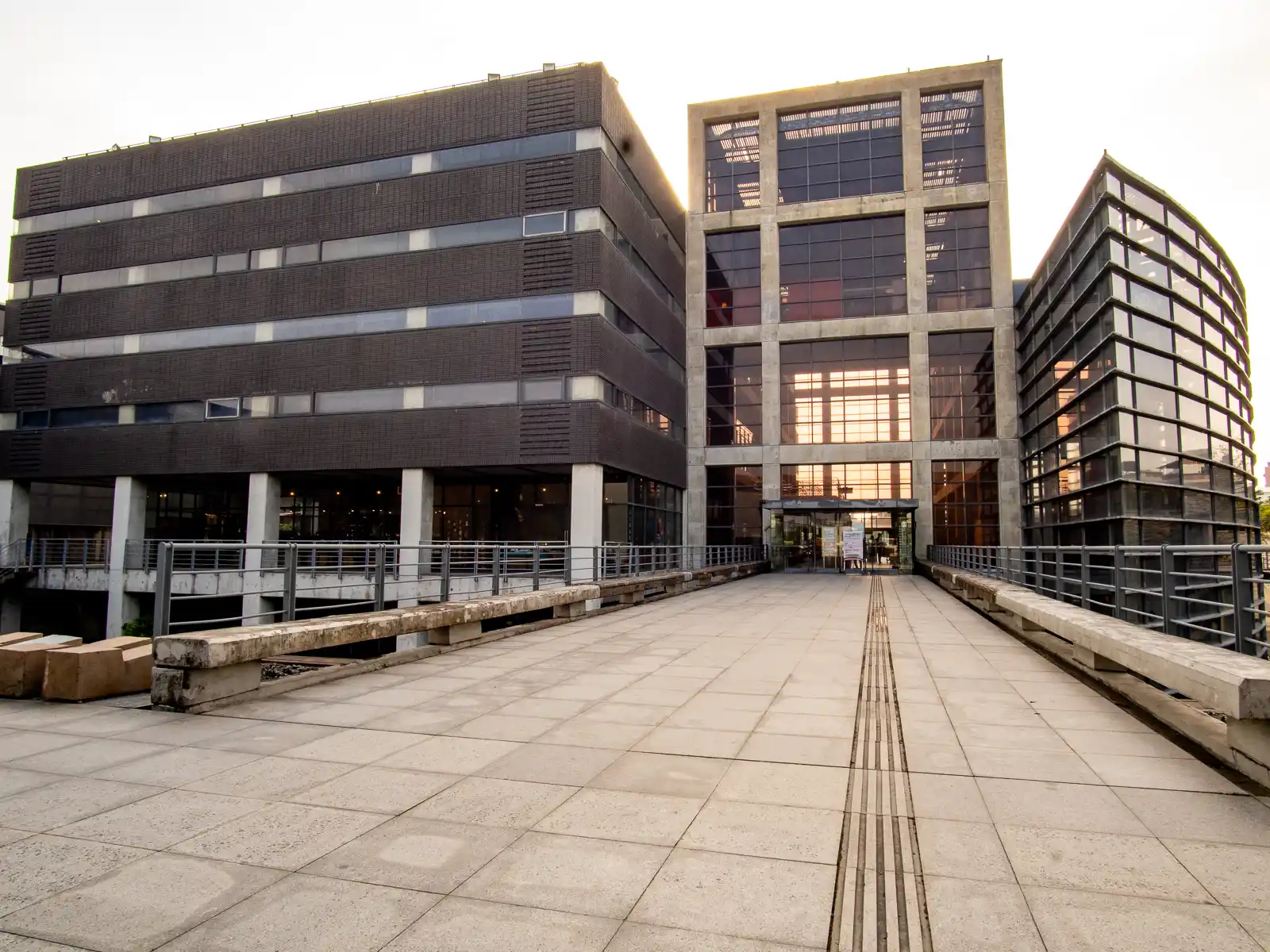 The glass exterior of the Yingge Pottery Museum is illuminated as the sun sets.