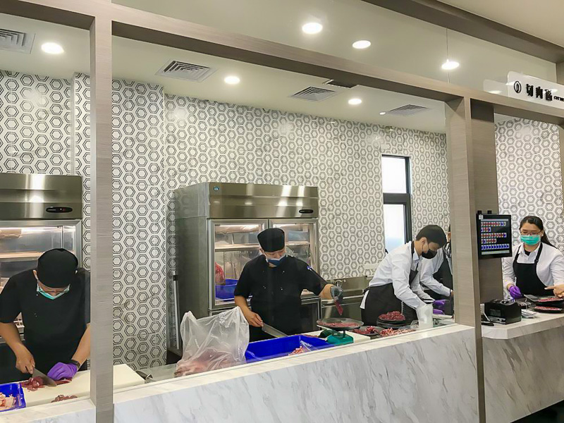 The kitchen at A-yu Beef Shabu Shabu is busy preparing meat.