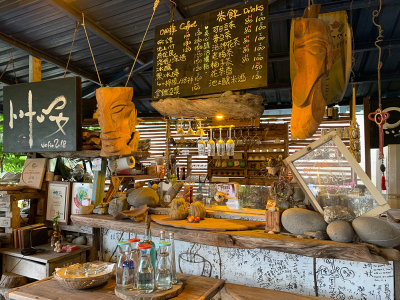 The bar of 4.5 KM Coffee is decorated with hand-carved driftwood.
