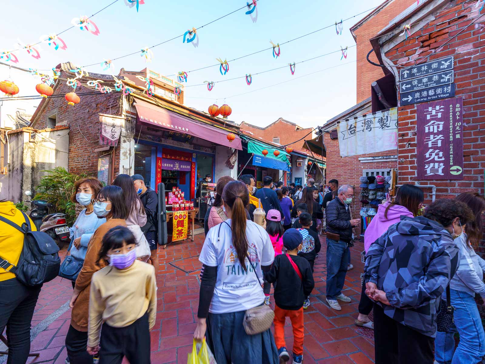 Tourists of all ages walk around Lukang Old Street.