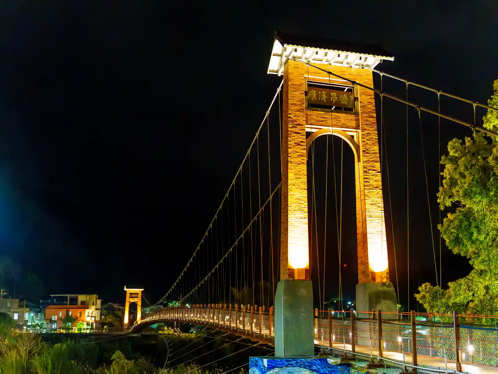 Kangji Suspension Bridge is seen illuminated at night.