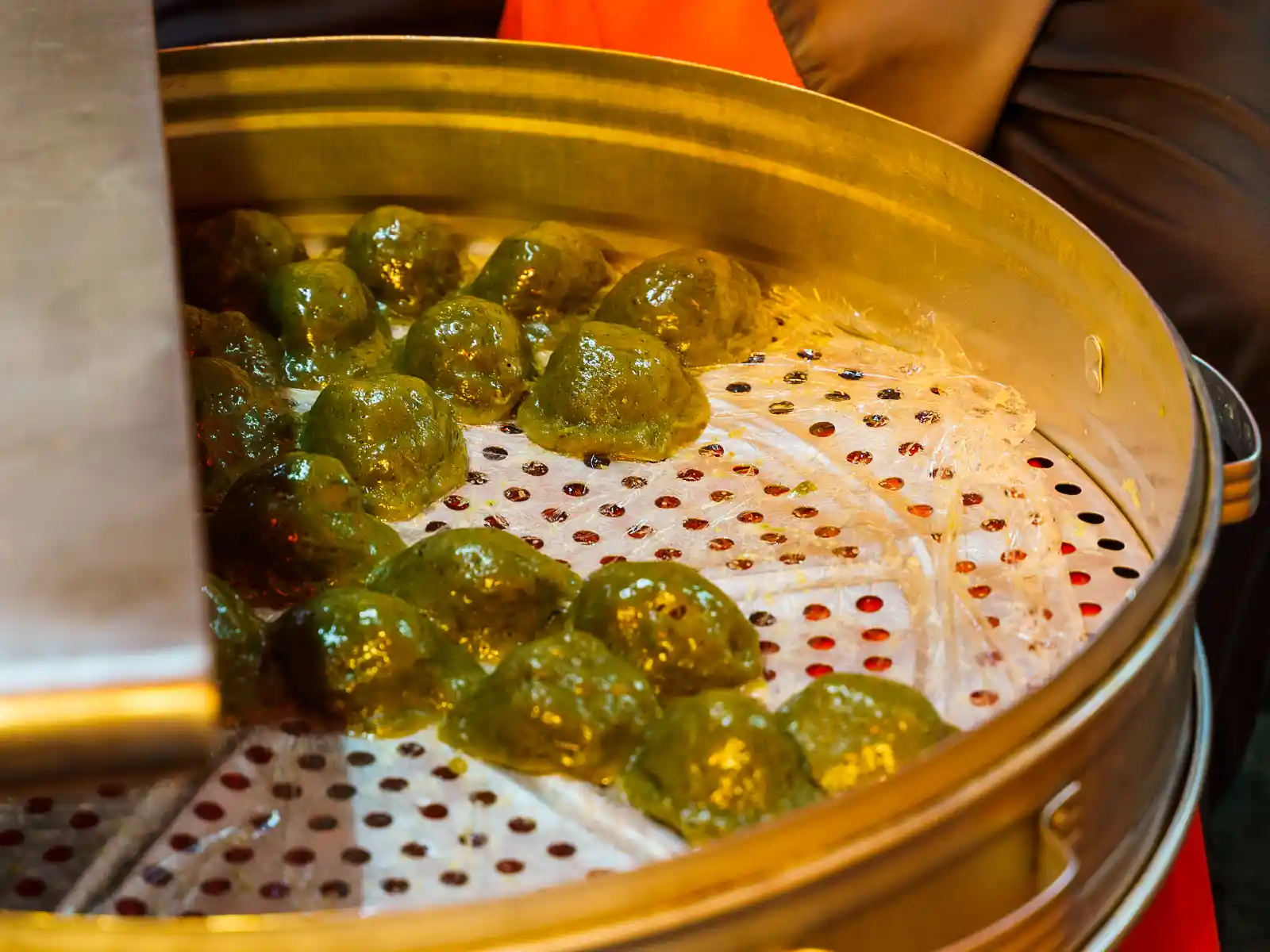 A steamer is filled a bunch of egg-sized balls made from glutinous rice known as "pig cage buns". 