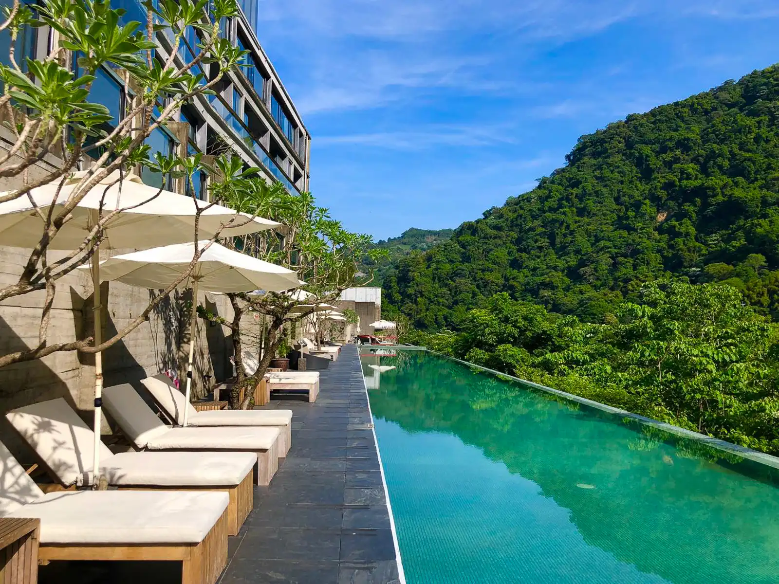 An infinity pool overlooks jungle on Onsen Papawaqa's balcony.