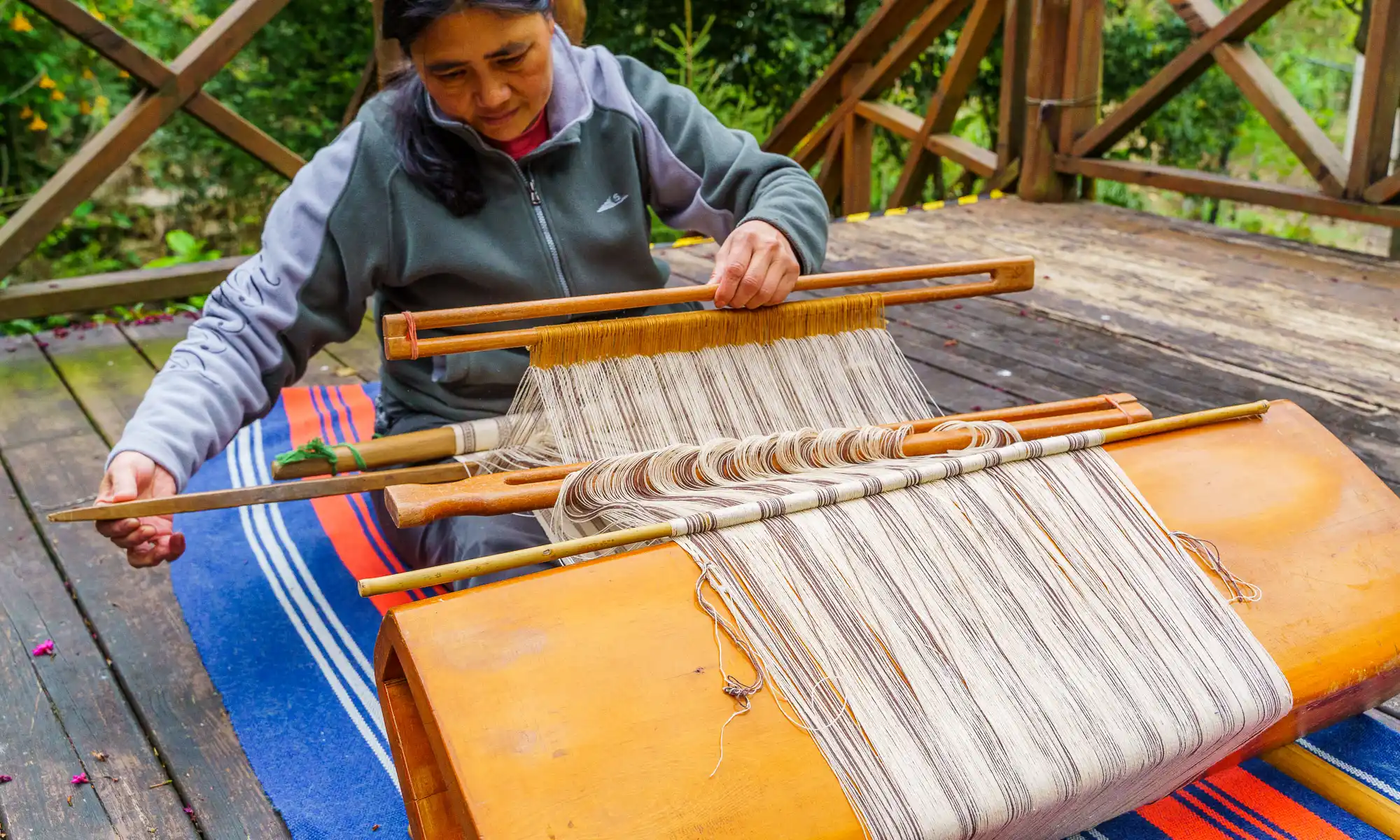 The owner of Raisinay Workshop demonstrates weaving using a traditional atayal loom.