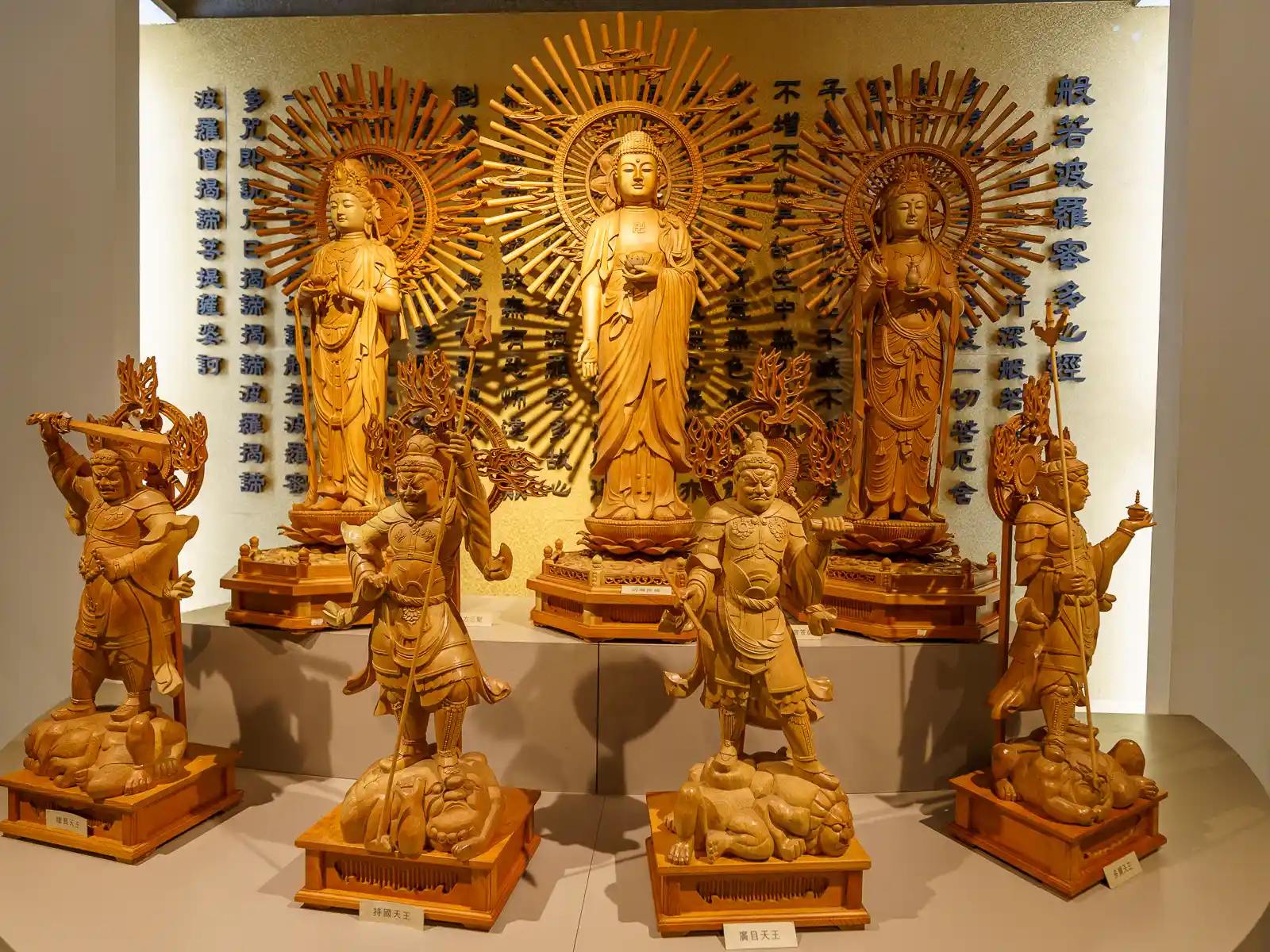 Seven woodcarvings of mythological figures and gods.