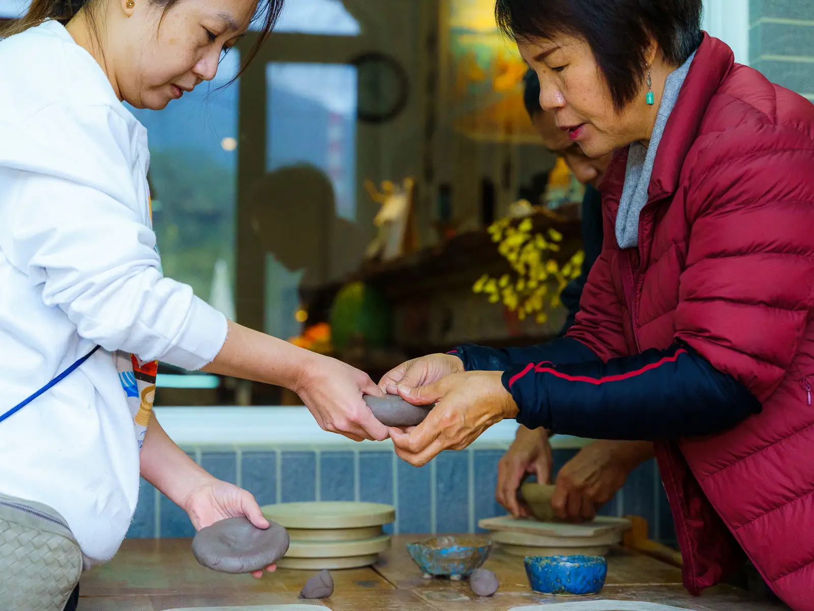 A guest participates in a DIY ceramics activity.