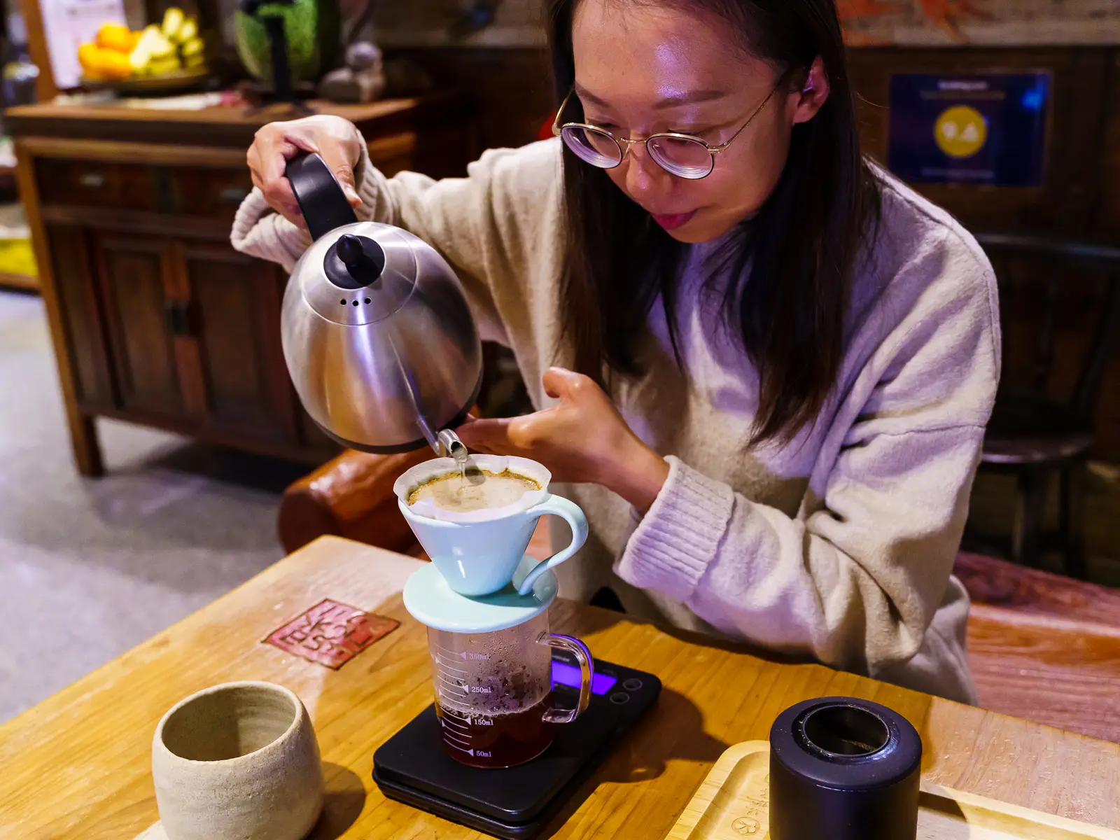 A cup of pour-over coffee is being brewed.
