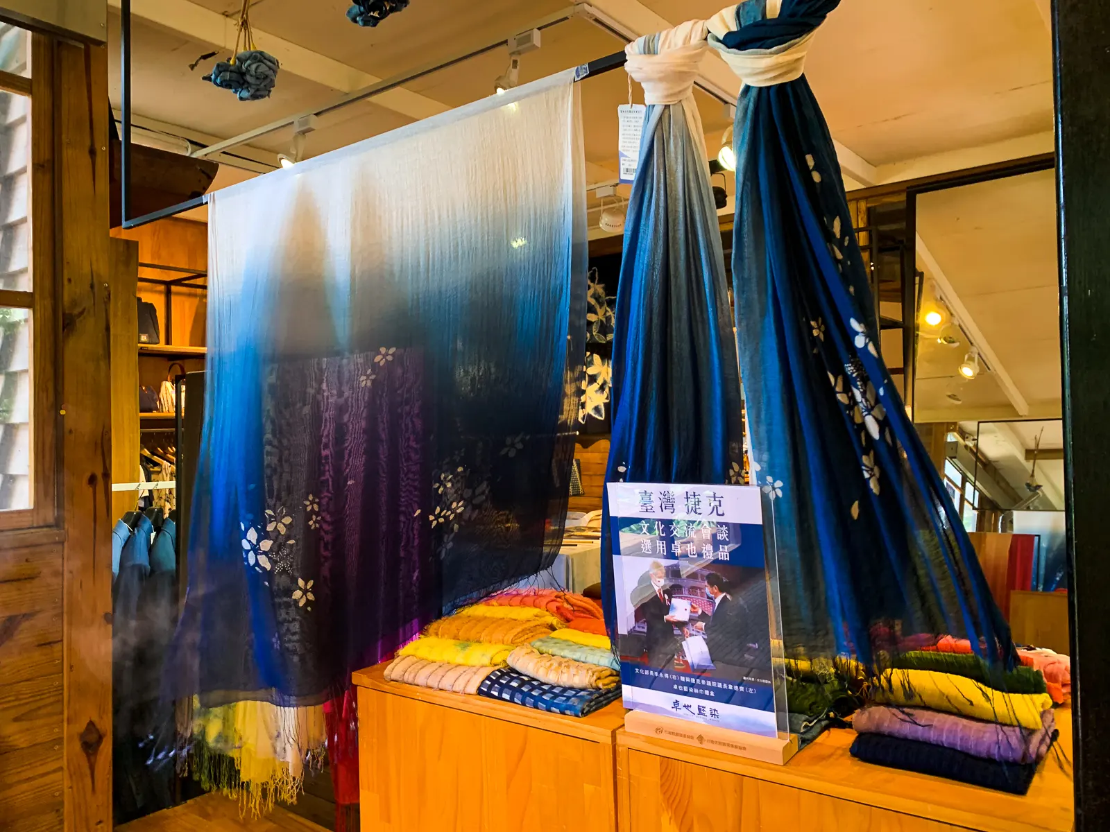 Silken indigo-dyed fabrics are on display in a shop.