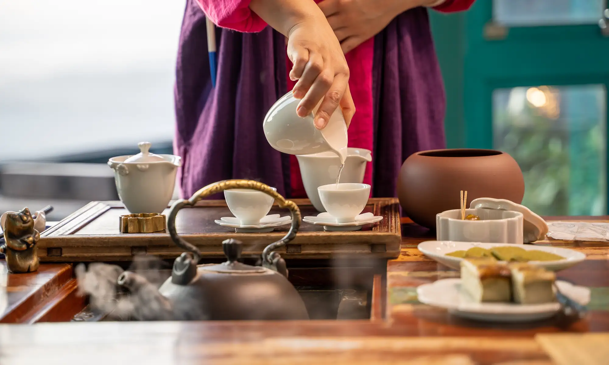 Tea is being served on elaborate wooden table in Jiufen Tea House.