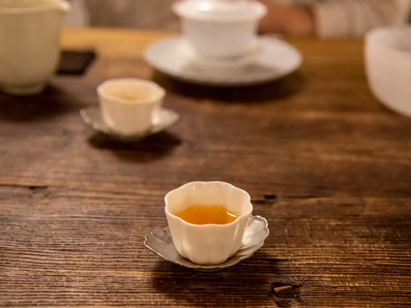 A cup of tea on a wooden table.