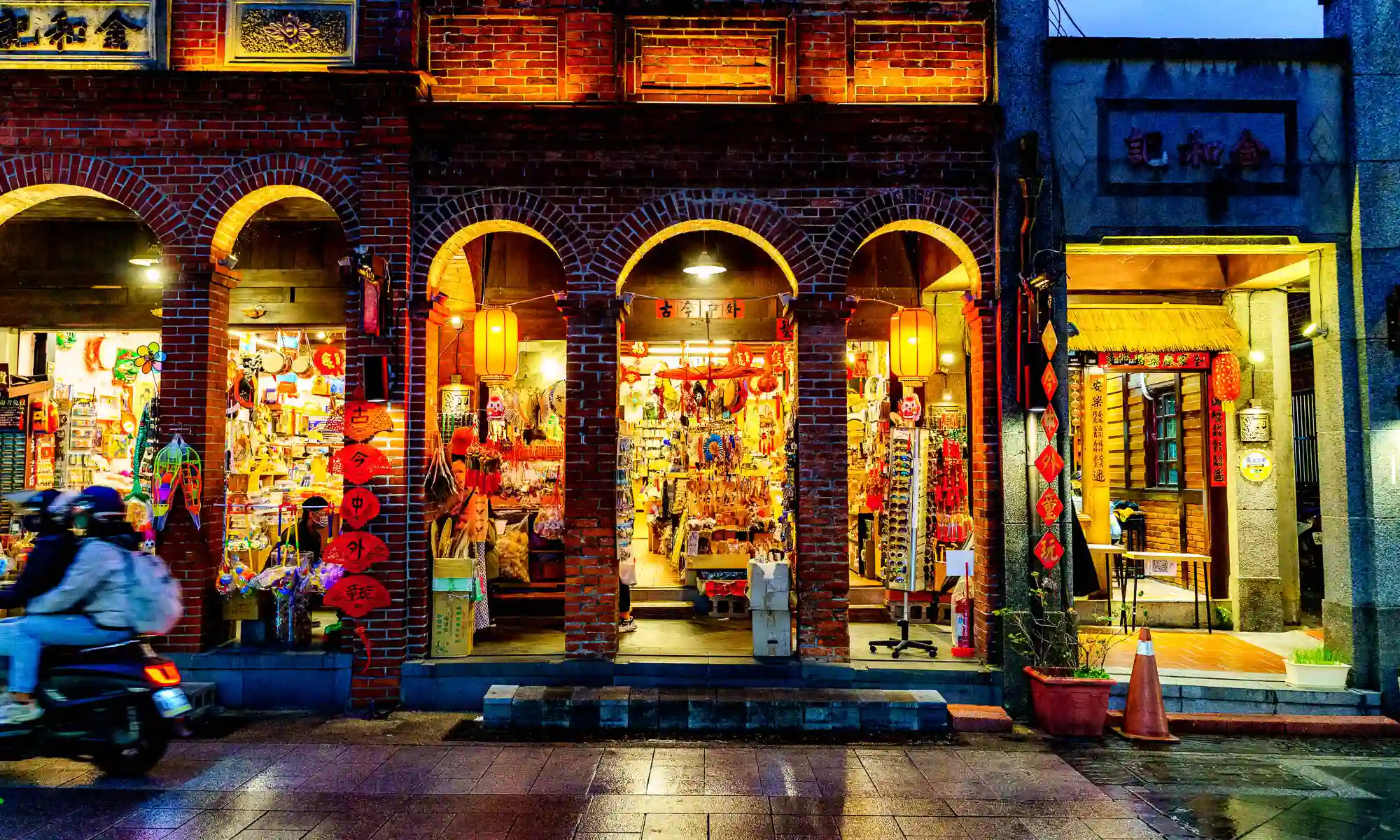 Inside the brightly lit arcade that lines Sanxia Old Street, stores sell souvenirs.