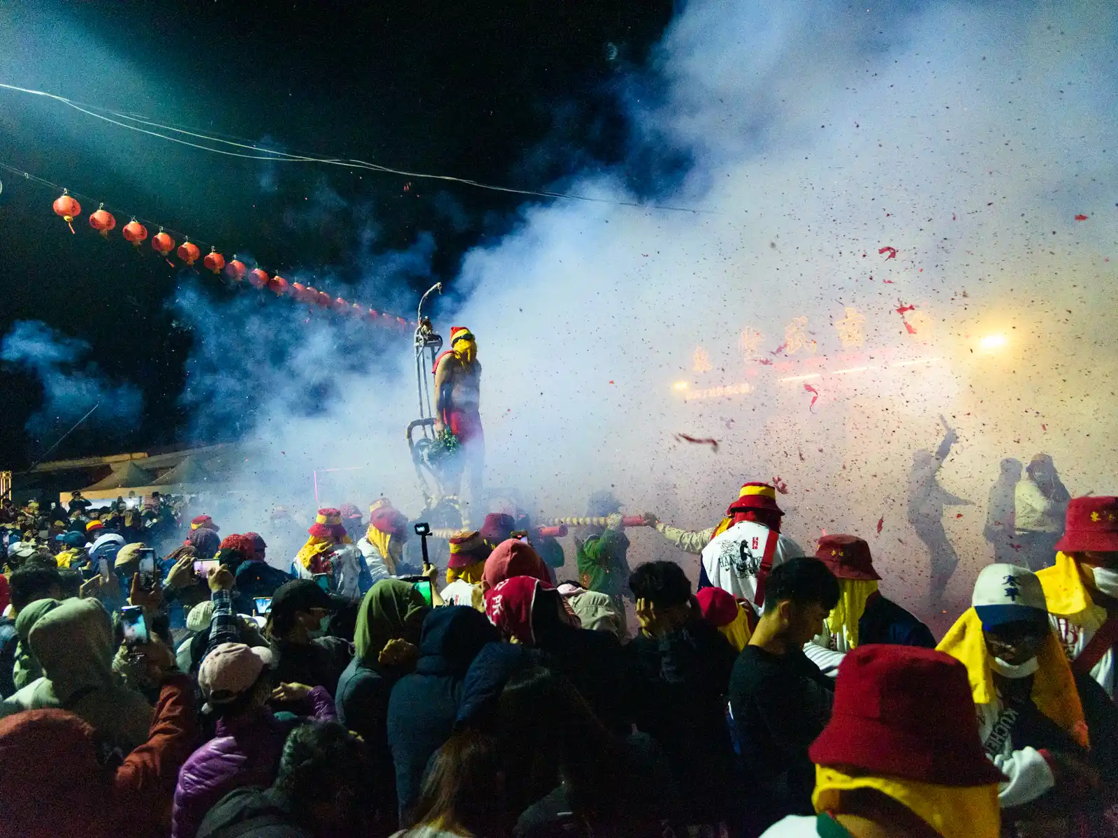 A cloud of smoke from firecrackers obscures the front of Xuanwu Temple after a round of bombardment.