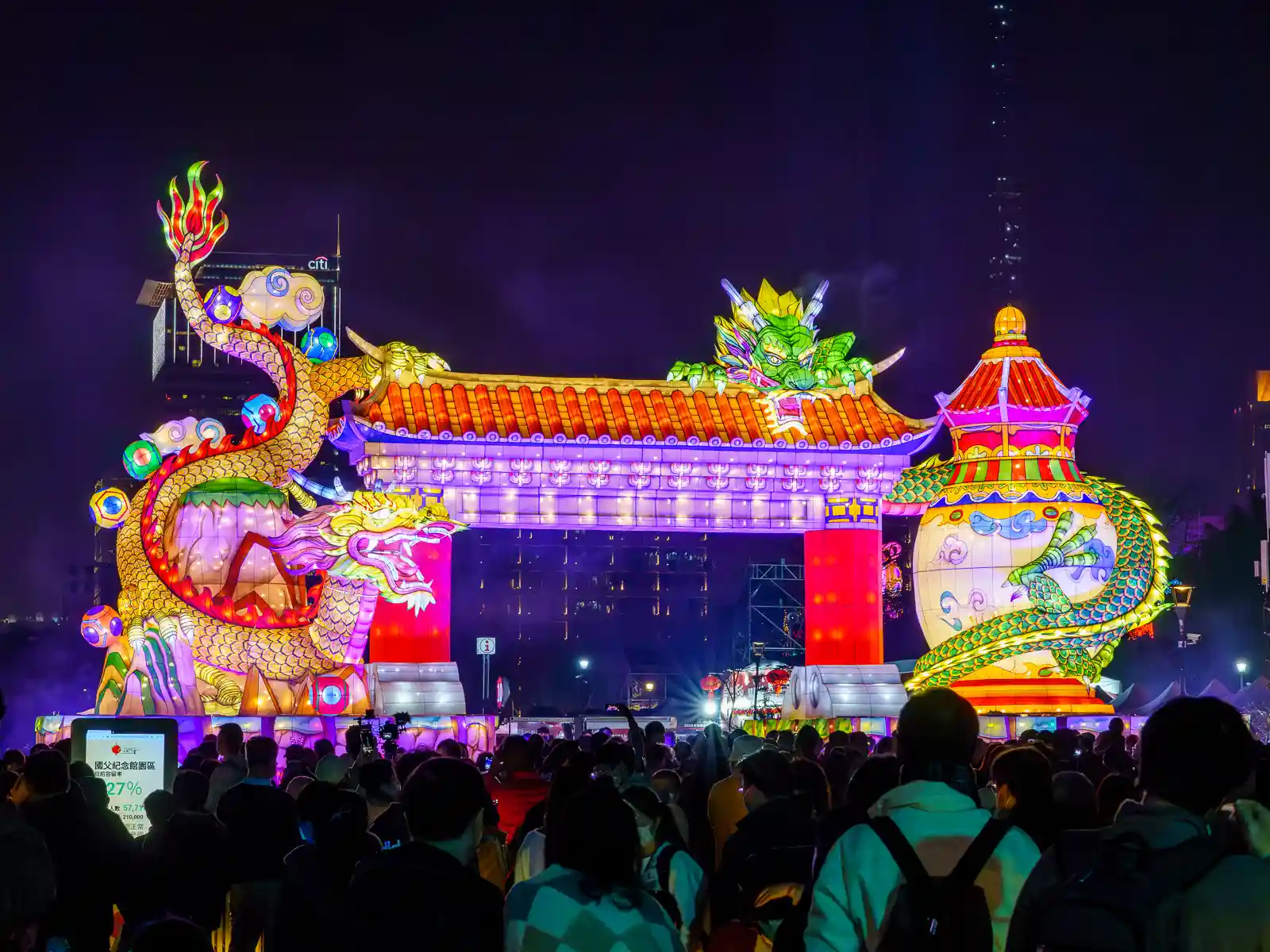 A lantern that is the size of a massive temple gate features two animated dragons.