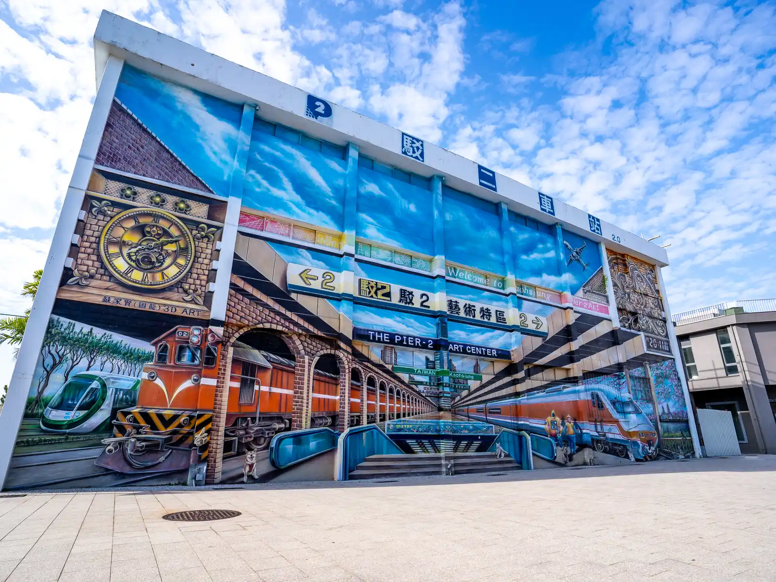 The wall of the old train station is painted with a mural depicting the inside of the train station.