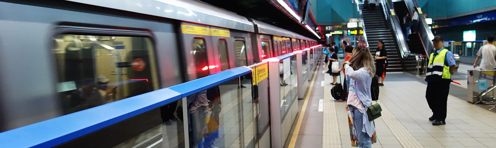 Passengers wait at an underground MRT Station.